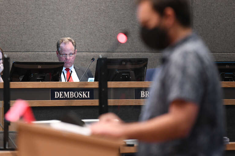 Mayor Dave Bronson watches as a man gives testimony in support of the mask mandate
This photo is available for free public use. Please provide credit in the following format: &quot;Photo used via Creative Commons license courtesy Paxson Woelber, The