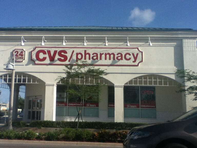 A CVS/pharmacy location in Pompano Beach FL located on Atlantic and Federal Hwy and using wooden signs