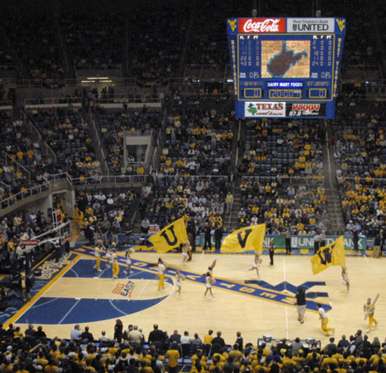 Rolling out the gold and blue carpet for team introductions at a West Virginia University men's basketball game