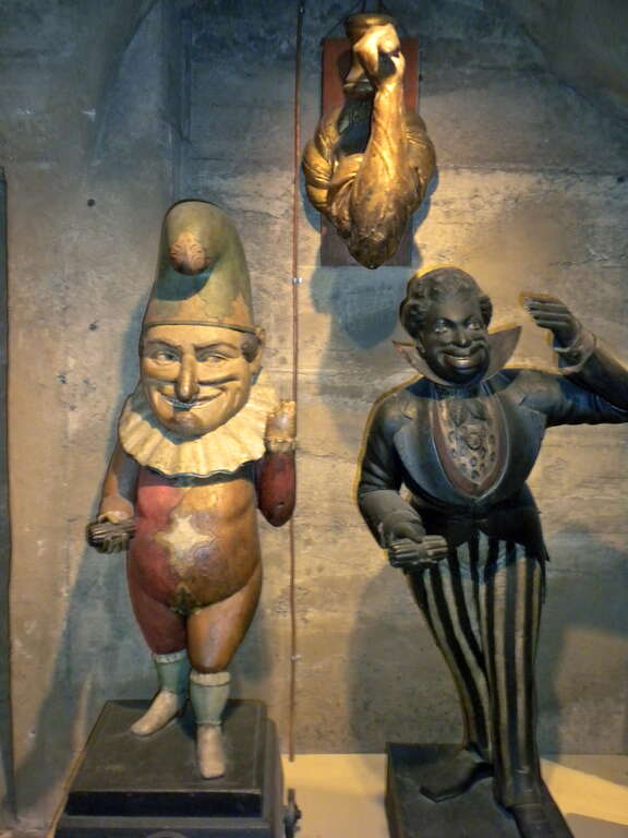 19th century cigar store figures from Mercer Museum in Doylestown, Pennsylvania.  Not all such figures were &quot;Cigar Store Indians&quot;.  The middle figure, which is hard to see here, is an arm and hammer.