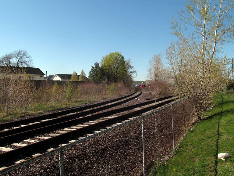The abandoned spur track of the Medford Branch in April 2017. The track at right was disused at the time, but was repaired around 2019 for use as a passing siding on the Haverhill Line.