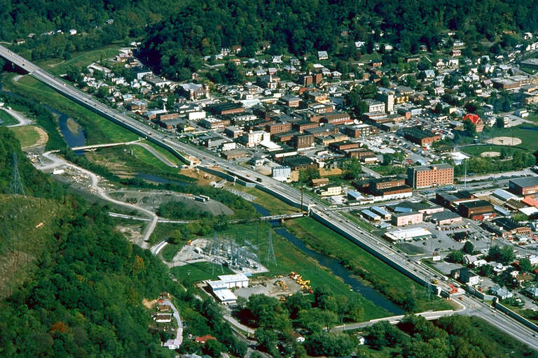 Aerial view of Harlan, Kentucky, USA. View is to the northeast. The main highway, U.S. Route 421, runs diagonally across the picture. The U.S. Army Corps of Engineers has constructed levees and a long floodwall along the Martins Fork River to prevent