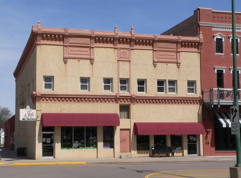 Building at northeast corner of 5th and Colorado Streets in Minden, Nebraska.  The red brick building at the right edge of the picture is the W.T. Thorne Building, a.k.a. Hostetler's Opera House, which is listed in the National Register of Historic
