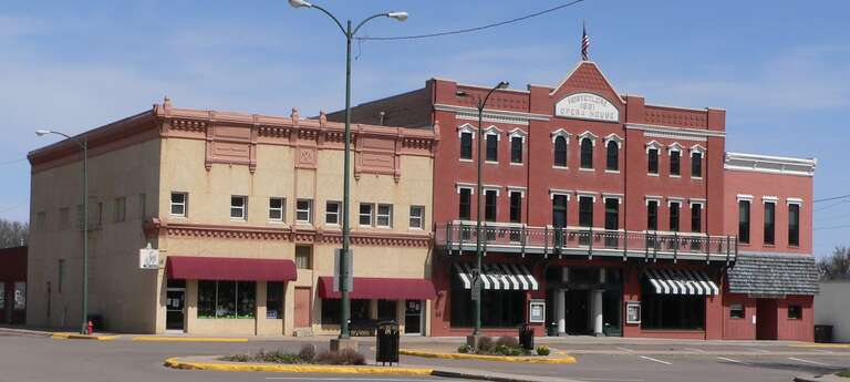North side of 5th Street east of Colorado Street in Minden, Nebraska.  The three-story red brick building in the center is the W.T. Thorne Building, a.k.a. Hostetler's Opera House.  The Renaissance Revival building was constructed in 1891; it is