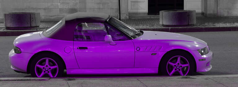 This car was parked at the curb in front of the Portland City Hall that was illuminated with &quot;pink&quot; light in support of Breast Cancer Awareness during the month of October.  From the other side the car is white. as seen in my photo from two days ago.