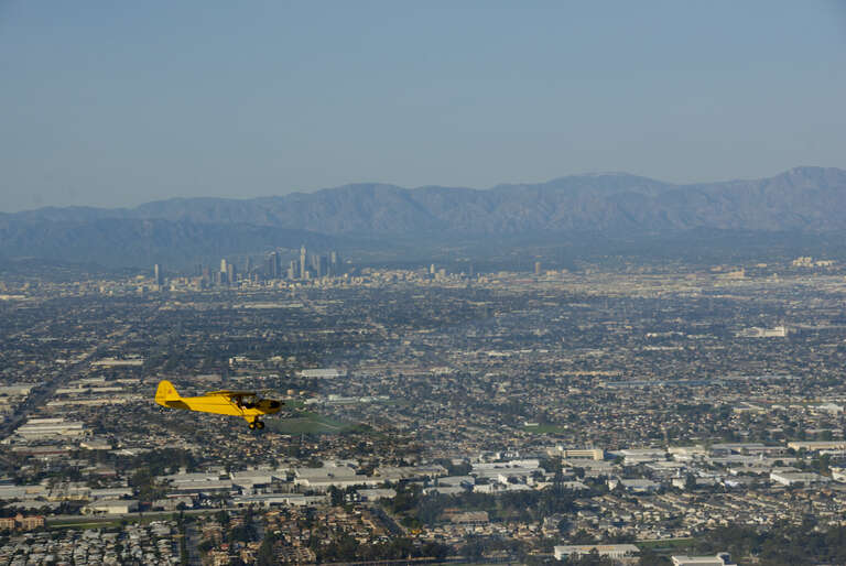 Piper Cub over Los Angeles from a hovering Eureka, hey cubby you can't do this!