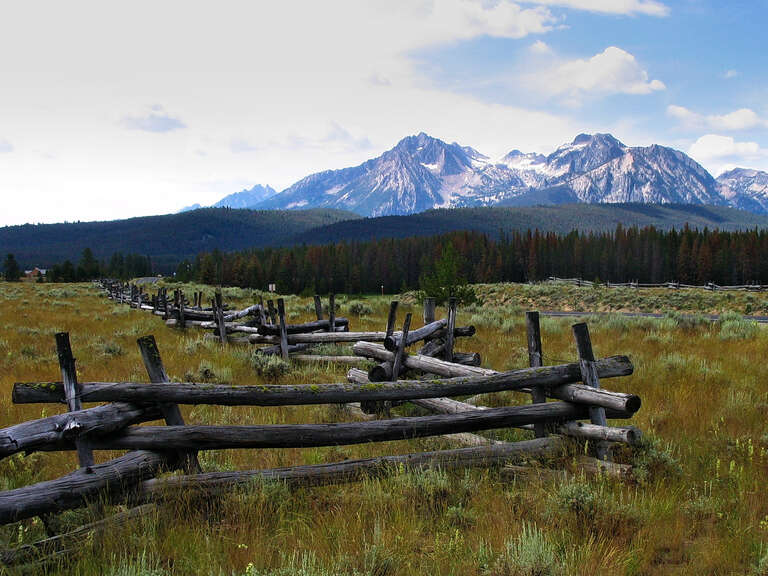500px provided description: Ranchland scene on the road to Sun Valley Idaho [#valley ,#pasture ,#hill ,#grand teton ,#rural scene ,#seasons ,#grazing ,#alpine ,#mountain peak ,#mountain pass ,#mountain range ,#wooden fence ,#snowcapped]