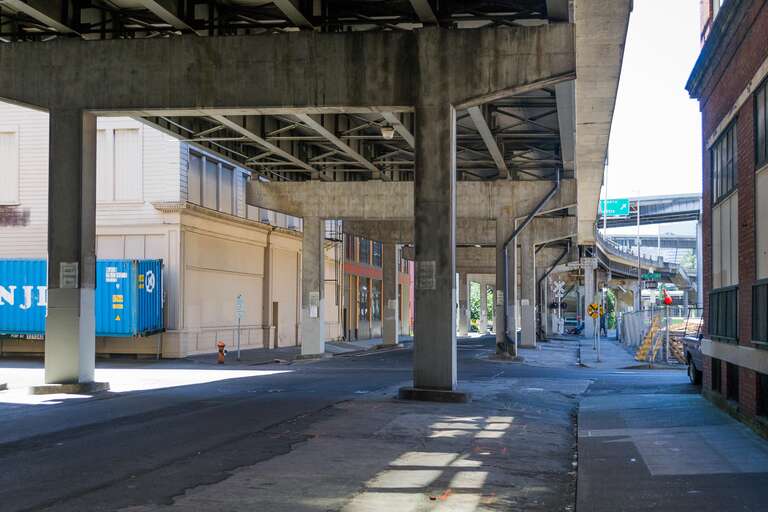 SE 2nd and Morrison Streets under the Morrison Bridge. The John Deere Plow Company building is to the right.