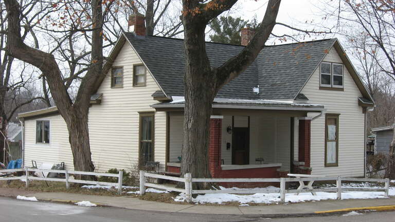 Front and eastern side of the house located at 801 W. Seventh Street in Bloomington, Indiana, United States.  Built in 1909, it is a part of the Bloomington West Side Historic District, a historic district that is listed on the National Register of