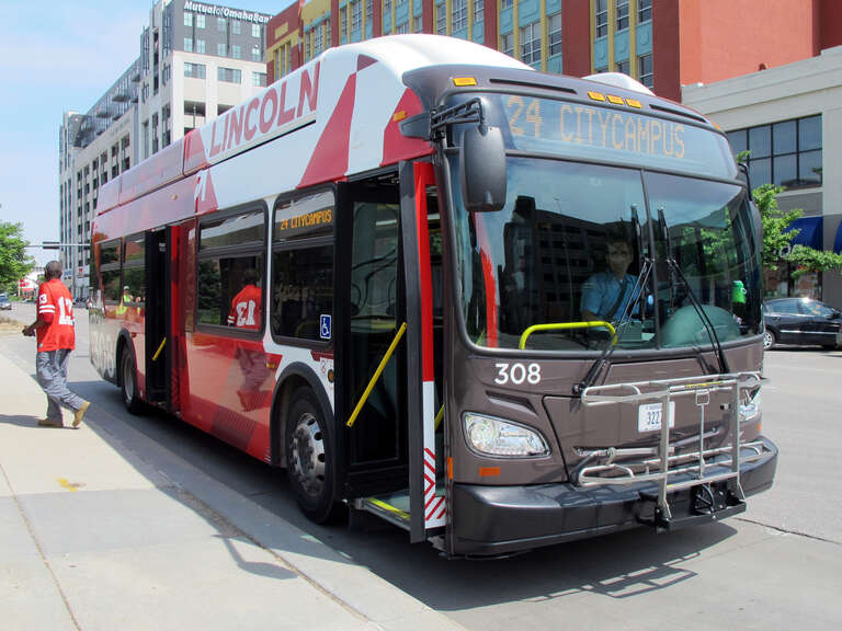 Photo of StarTran bus #308, route #24 (Holdrege) running CNG in downtown Lincoln, Nebraska.  Photo is taken at the bus stop on the north side of "Q" Street in-between N. 12th &amp;amp; N. 13th Streets, looking east-southeast.