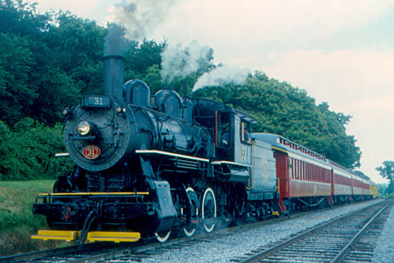 Strasburg Rail Road locomotive 31 with an excursion train at Groff's Grove, a picnic stop on the line between Strasburg and Paradise, Pennsylvania.  It was built in 1908, and served the Grand Trunk Railway and Canadian National Railway.  It has an