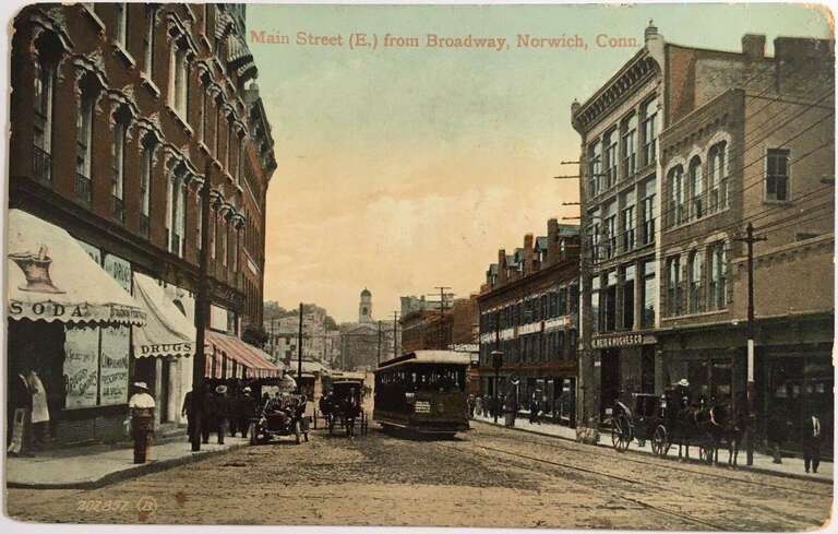 Divided back postcard of Main Street in Norwich, with a streetcar signed for Baltic and other destinations on the Willimantic line, postmarked in 1910