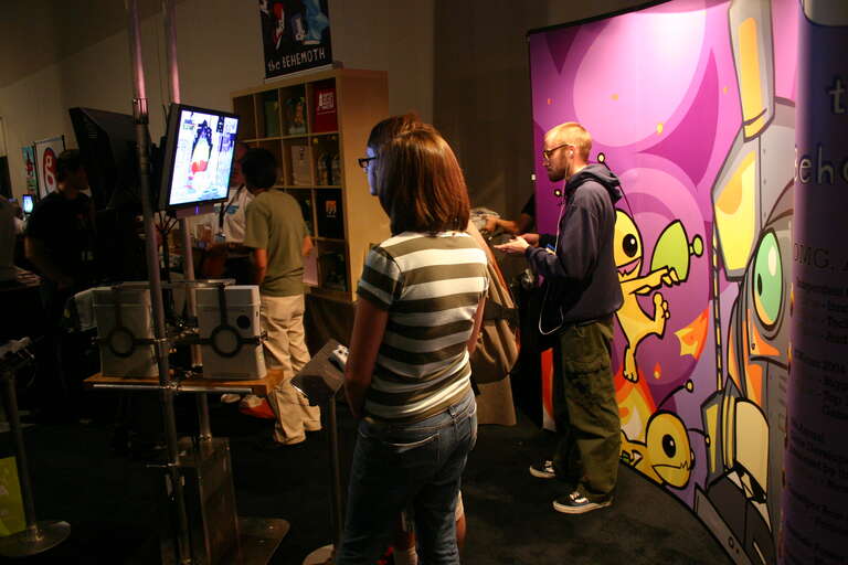PAX 2006 attendees playing Castle Crashers at The Behemoth's booth.