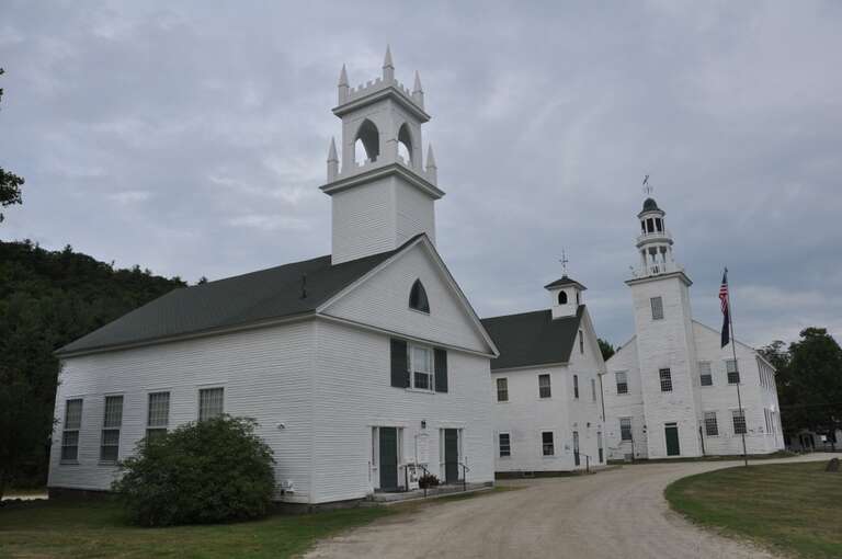 The municipal buildings (Congregational Church, former schoolhouse, and town hall) of Washington, New Hampshire.  Part of the Washington Common Historic District.