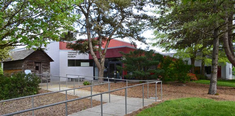 The Washington County Museum, on Portland Community College's Rock Creek Campus.  At left is the historic former Washington County Jail, a log building that was in use as a jail from 1853 to 1870.