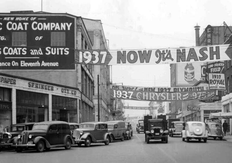 Portland's Burnside in 1937 is filled with advertisements for new cars. This is looking west on West Burnside Street from 10th Avenue, as SW Oak Street veers off at left