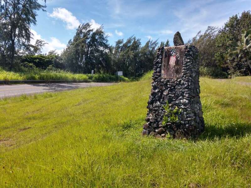 Hana Highway Millennium Trail monument at the junction of Route 36/360 and 365, with a view of  Route 360 (left) and Route 365 (Kaupakalua Road, Right). Route 36 is behind the photographer. Just under the &quot;Adopt a Highway&quot; sign in the background