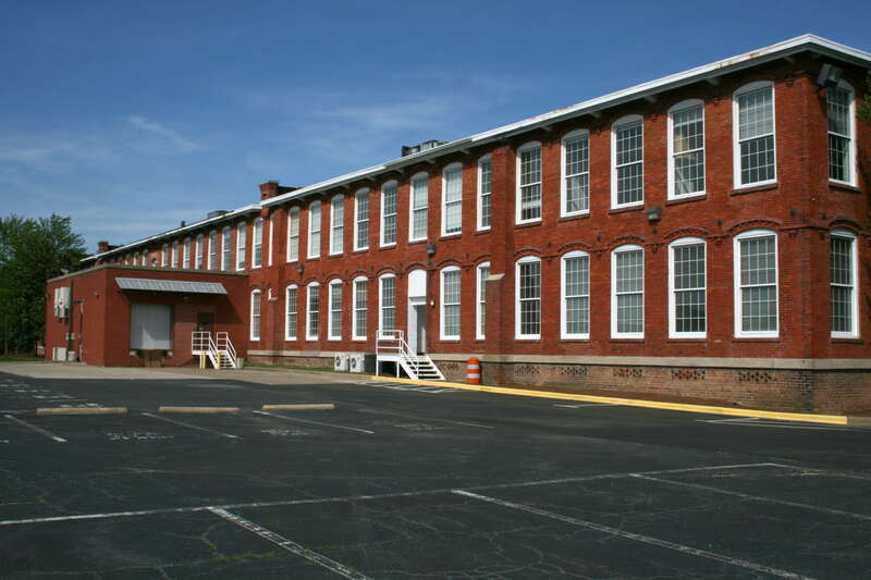 The parking lot and loading dock in the rear of the Erwin Square Mill building in Durham, North Carolina.