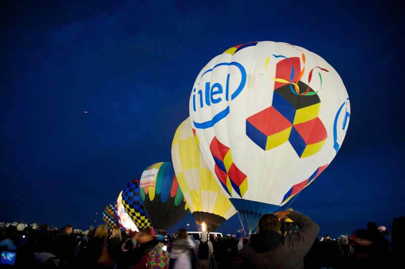 Dawn Patrol is a small group of balloons that go up before the rest to check conditions. They light up before dawn for a 5:45am departure. Albuquerque International Balloon Fiesta, 2012. Over 750 ballons on site.