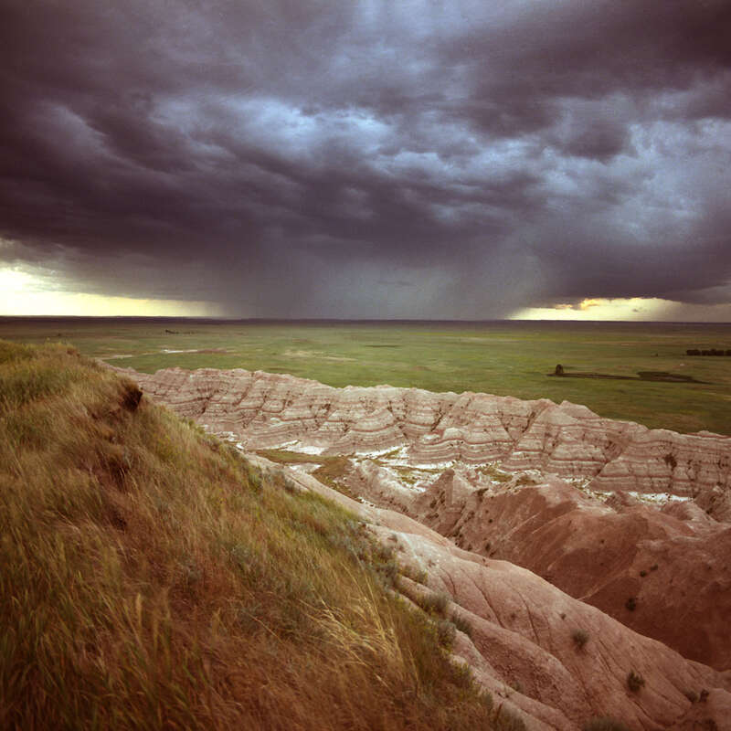 500px provided description: An afternoon rainstorm over the Badlands N.P. - South Dakota [#clouds ,#rain ,#storm ,#plains ,#Badlands N.P.]