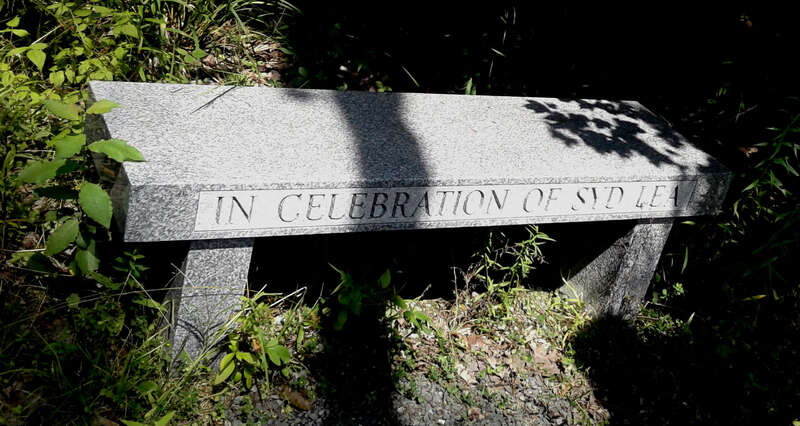 Granite Syd Lea bench on poem trail at Robert Frost Place in Franconia, NH.