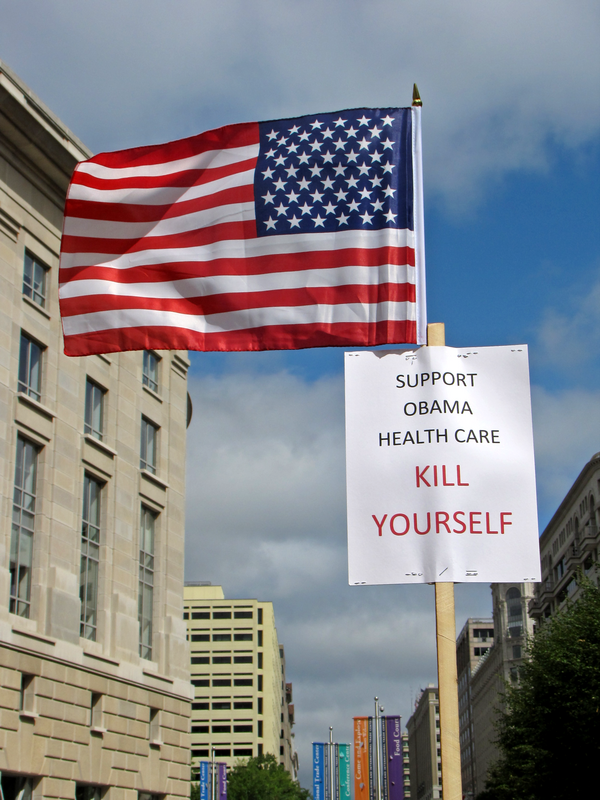A person holds up a flag with a sign criticizing the Obama healthcare plan at the Taxpayer March on Washington, a Tea Party-affiliated demonstration espousing primarily right-wing values, on September 12, 2009.
More at The Schumin Web:
&amp;lt;a