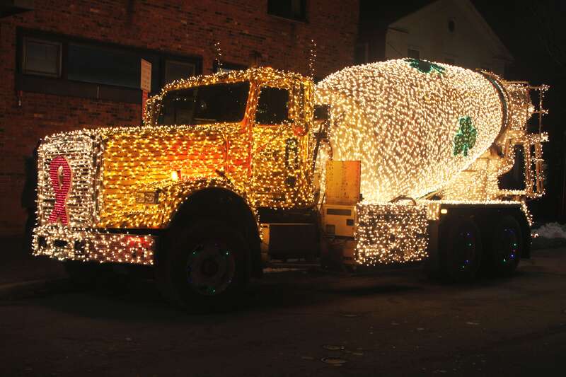A concrete mixing truck decorated with festive holiday lights on Church and Cherry Streets, Burlington VT USA.