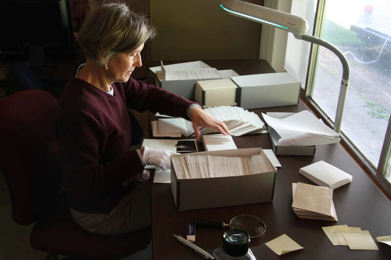 A volunteer at work sorting historic images for the park's photo library.

NPS Photo by Kevin Bacher.