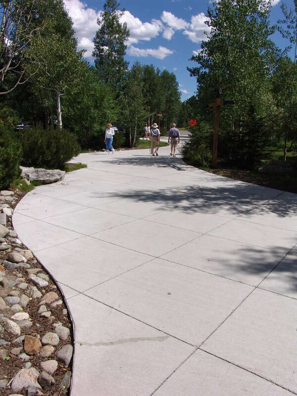 Visitors to the Sawtooth National Recreation Area approach the Headquarters on a winding path through landscaped rocks and trees.