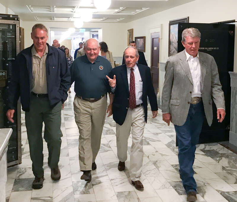From left, U.S. Department of Interior Secretary Ryan Zinke, Agriculture Secretary Sonny Perdue, U.S. Senator James E Risch, and Idaho Governor C.L. Butch Otter are in the Idaho State Capitol Building, about to meet Federal and State elected