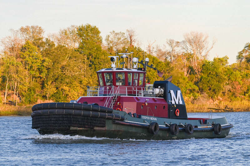 Moran Towing tugboat, COOPER MORAN - IMO 9812547, on the Savannah River beside the Savannah Historic District, Georgia, USA on November 27, 2023.