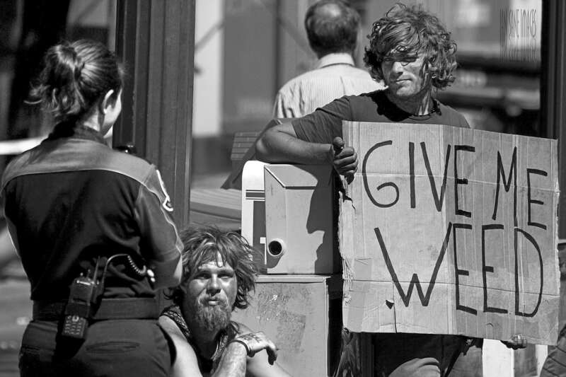 Technically speaking this isn’t one of my better shots.  Since the man holding the sign is homeless he probably doesn’t own the best in hair products, thus, his extremely long bangs were creating a massive shadow over his eyes.  I did what I could to