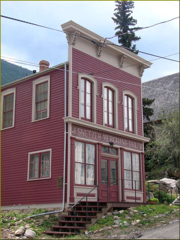 (1 in a multiple picture set)
This building was typical of stores back in the day when the family lived above the store. In this case the man was, as he put it on his sign, 'J. Snetzer Merchant Tailor.'  I think such a store speaks to the prosperity