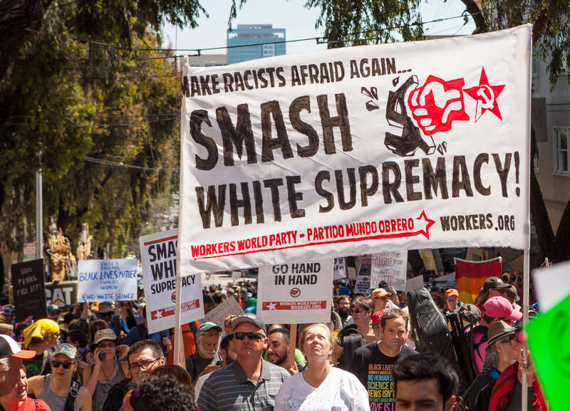 Protesters hold a Workers World Party banner reading "Make Racists Afraid Again... Smash White Supremacy!" at a Patriot Prayer counter-protest in San Francisco.