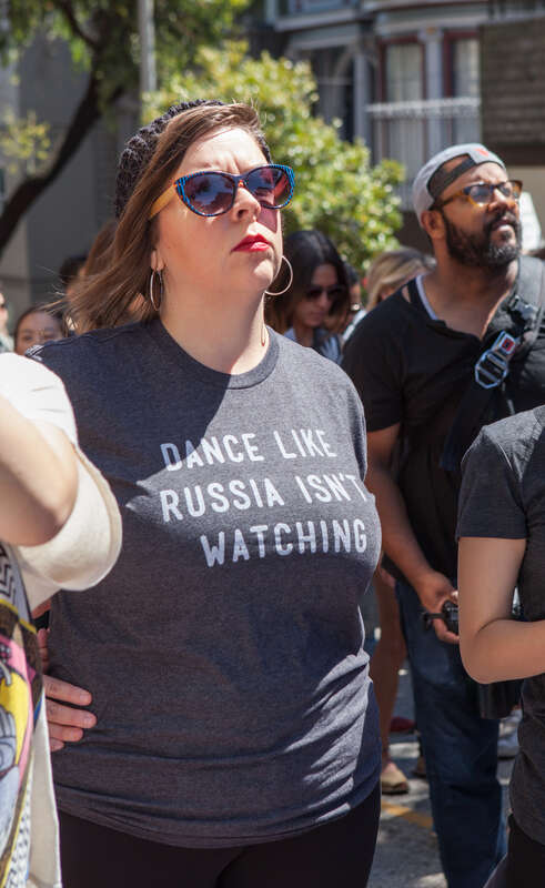 A protester wearing a shirt reading "Dance Like Russia Isn't Watching" attends a Patriot Prayer counter-protest in San Francisco.