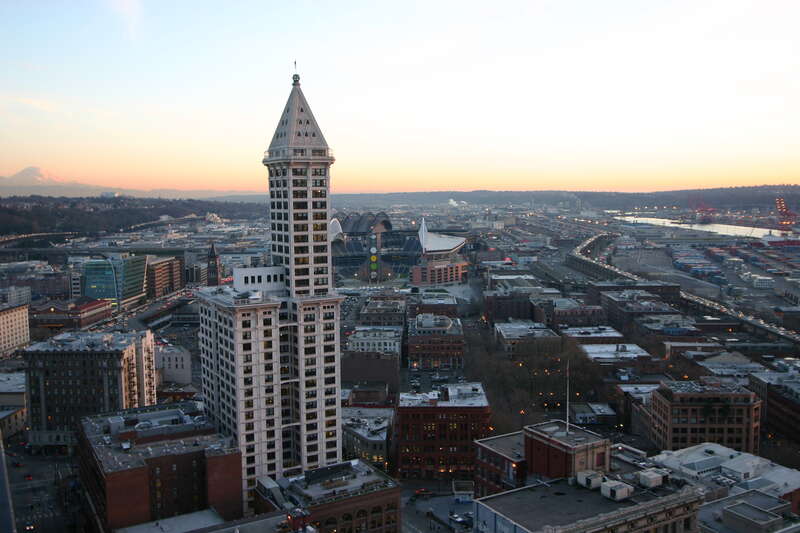 Photo of the Smith Tower, with Seahawks Stadium and Mt. Rainer in the background; taken from the roof of the Pacific Building.