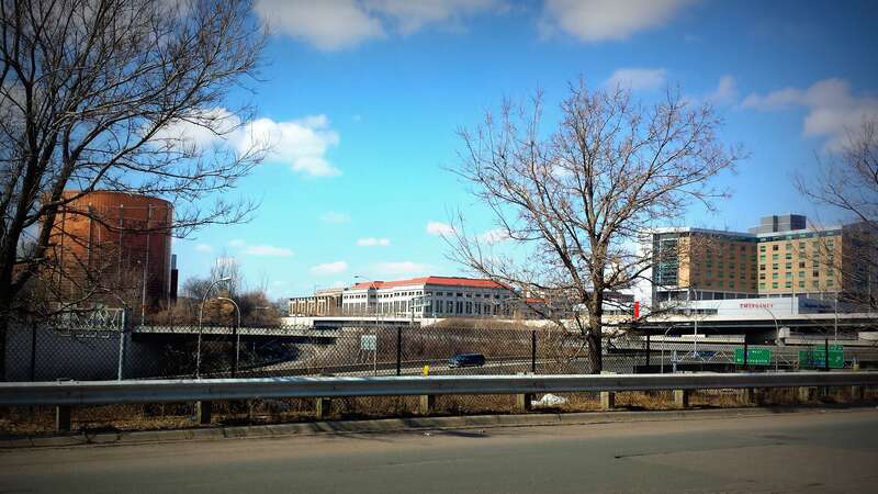View from Broadway Street in Saint Paul, Minnesota. Across the freeway are the Minnesota Department of Revenue Building and Regions Hospital. The cylindrical building is a district cooling plant.