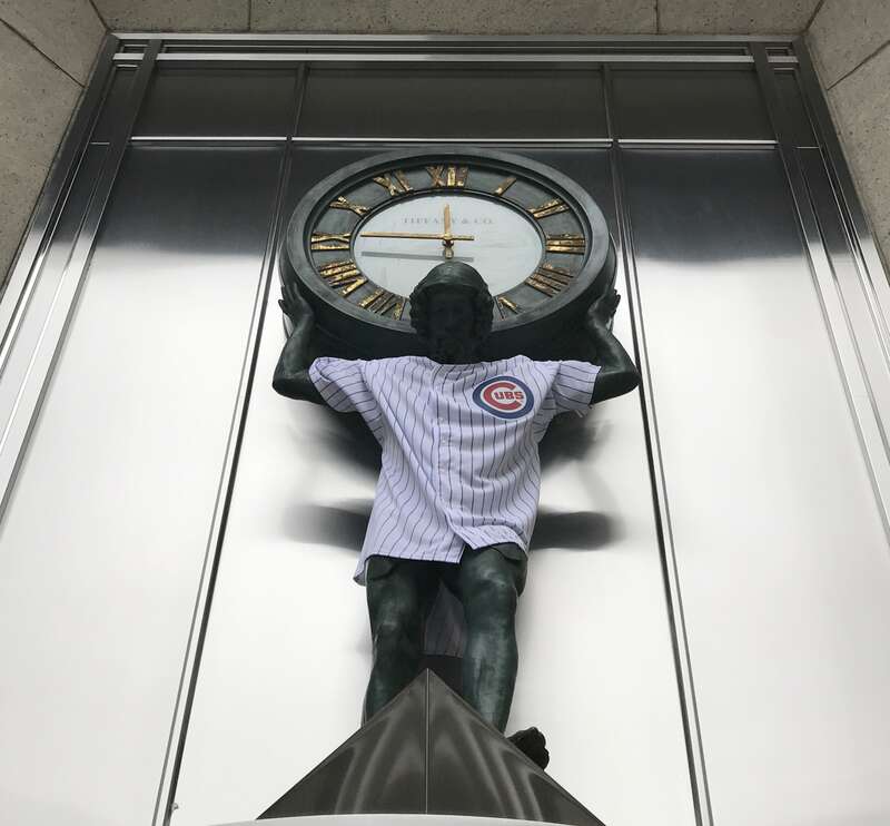 The statue holding the Tiffany clock on the Magnificent Mile is a Cubs fan.
