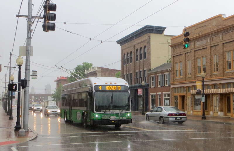 Greater Dayton RTA trolleybus 1404, a 2014-built Gillig/Kiepe dual-mode trolleybus, westbound on route 4, on Third Street at Williams Street, in a pouring rain.