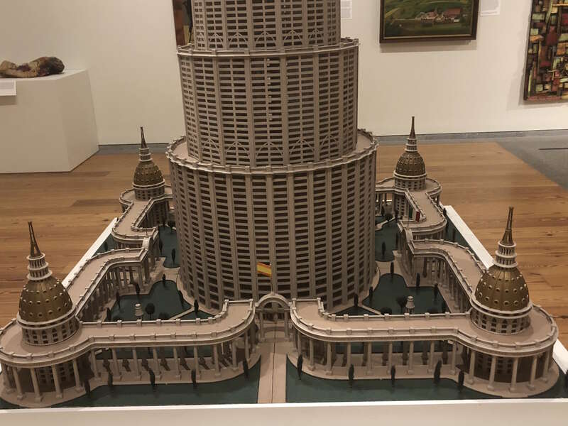 Encyclopedic Palace sculptural model view in a closer view from entrance with a flag of Spain. Model created by Marino Auriti. Collected by the American Folk Museum at New York, loaned to the Portland Museum of Art as part of the temporary &quot;American