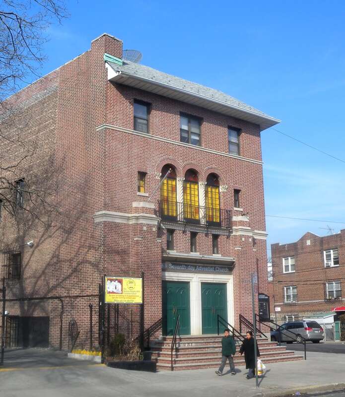 Looking northeast across Woodside Avenue at Jackson Heights Seventh Day Church on a sunny day.  ZIP 11377.