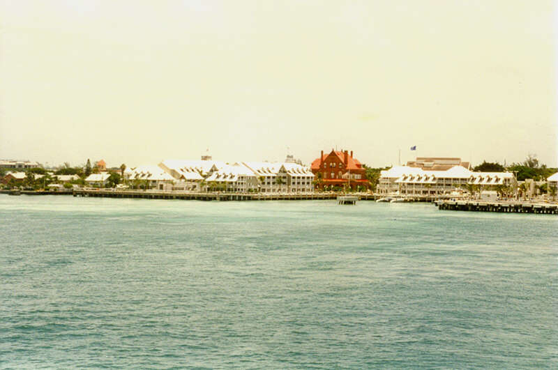The ship is leaving Key West.  The red building is the Old Customs House and post office,which was built in 1889-1891