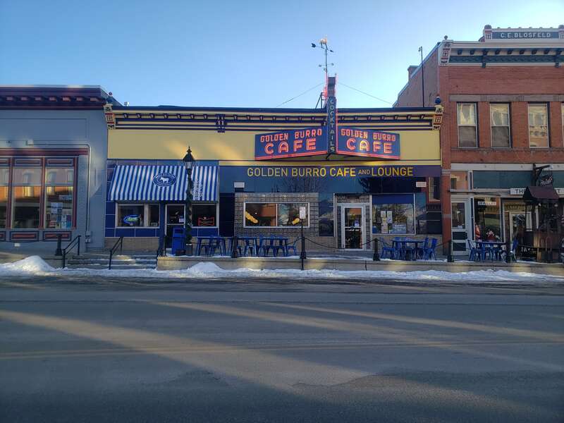 Golden Burro facade after removal of canopy and posts, repair/replacement of Vitrolite glass tiles, repair of iconic neon burro marquee, installation of Brass Ass Saloon awning, installation of matching sidewalk bollards, 2021-2022