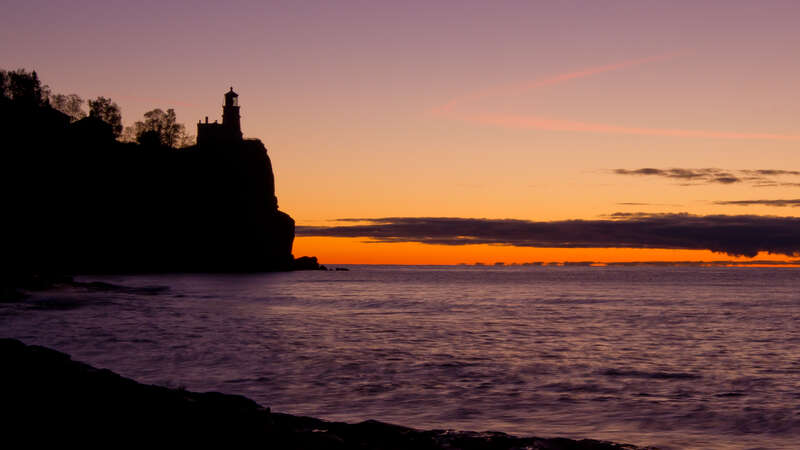 Splitrock Lighthouse during sunrise, the landmark monument makes a spectacular silhouette during the early hours of the day, this fall picture tries to signifies the beginning of the era where we no longer need the services of the ever so faithful