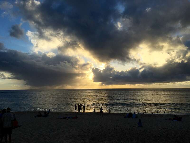 People at the beach with clouds