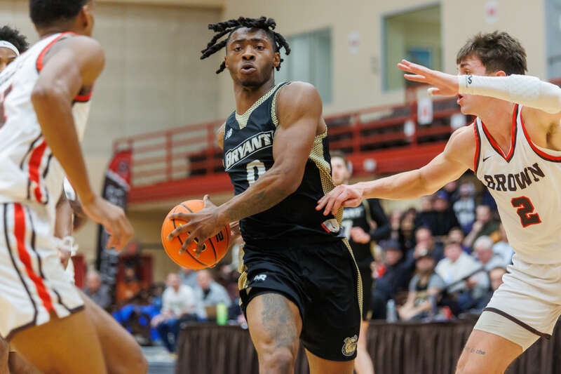 Bryant Bulldogs Earl Timberlake rushes past Brown's Felix Kloman. Bryant Bulldogs at Brown Bears mens basketball