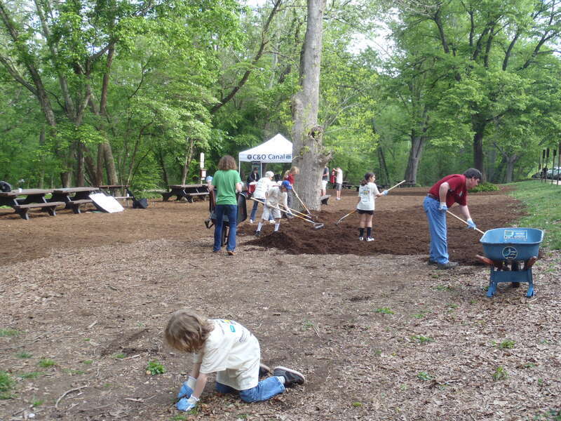 Volunteers spread mulch throughout the day use area and concession stand.