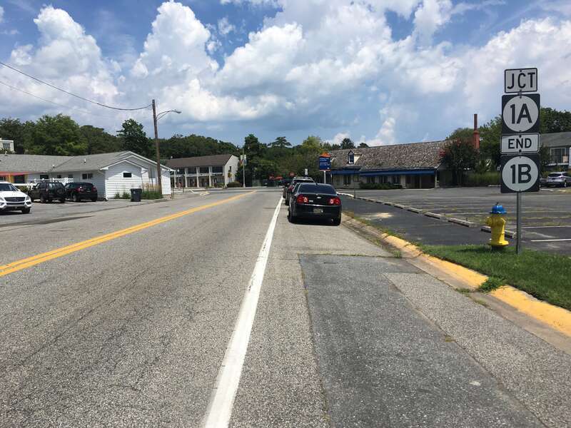 Northbound Delaware Route 1B (State Road) approaching its terminus at Delaware Route 1A (Rehoboth Avenue) in Rehoboth Beach, Delaware
