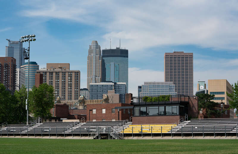 The stadium and field at DeLaSalle High School on Nicollet Island, with the skyscrapers of Downtown Minneapolis, Minnesota in the background.