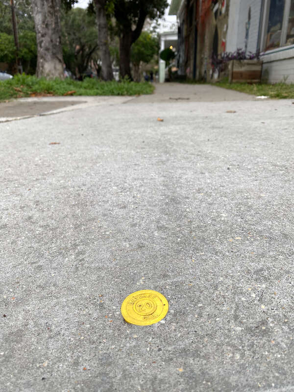 A utility repair tag of Entergy Gas embedded on a sidewalk pavement in the Garden District of New Orleans to indicate that the pavement was done in 2020.